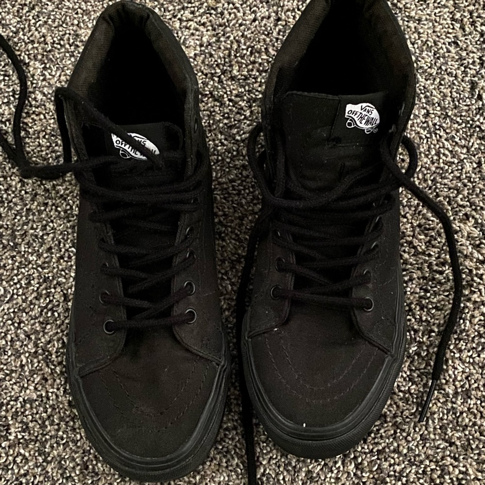 All black high top Vans